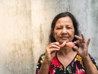 Takma diş tutan eski Taylandlı kadın