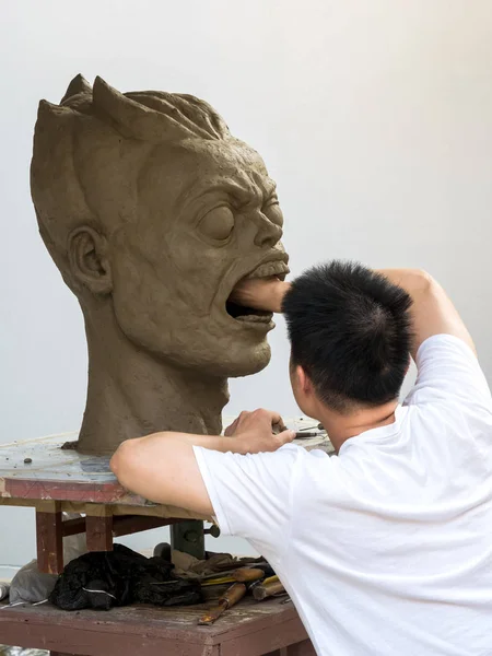 Sculptor working on his clay sculpture — Stock Photo, Image