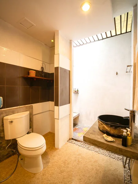 Luxury bathroom with sanitary ware in warm light.