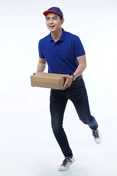 Young man delivery in blue uniform with packages — Stock Photo, Image