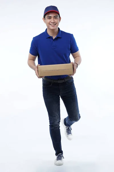 Young man delivery in blue uniform with packages — Stock Photo, Image