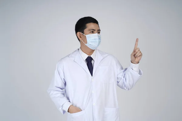 Asian doctor man in flu mask against with a corona virus pandemic, or prevent flu disease or cold during winter