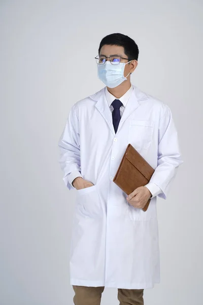 Asian doctor man in flu mask against with a corona virus pandemic, or prevent flu disease or cold during winter