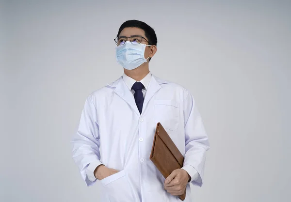 Asian doctor man in flu mask against with a corona virus pandemic, or prevent flu disease or cold during winter