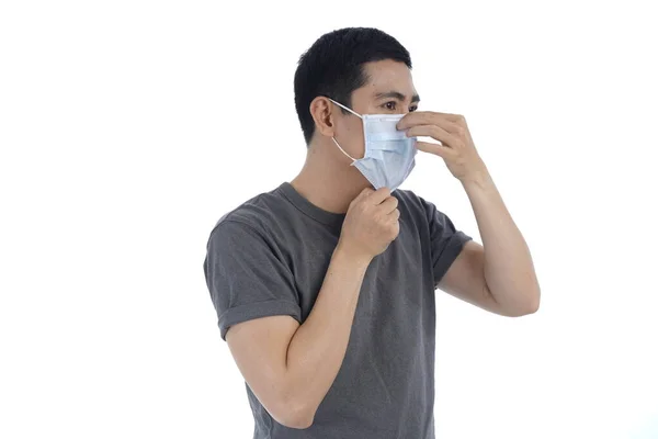 Asian young man in flu mask against with a corona virus pandemic, or prevent flu disease or cold during winter