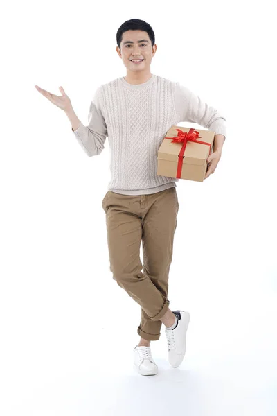 Asian Young Man Knitted Sweater Gray Background Giving Red Ribbon — Stock Photo, Image