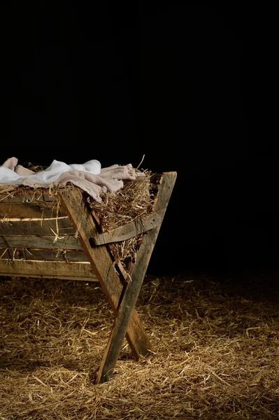 Manger with Clothes on Hay — Stock Photo, Image