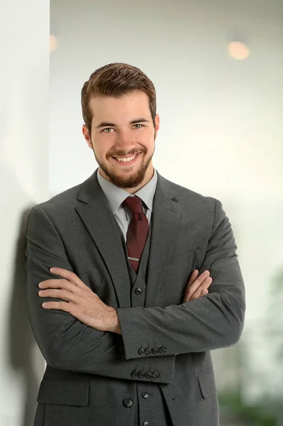 Businessman Leaning on Office Wall — Stock Photo, Image