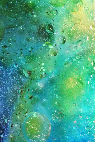 Abstraktní pozadí s bublinami v zelené a modré — Stock fotografie