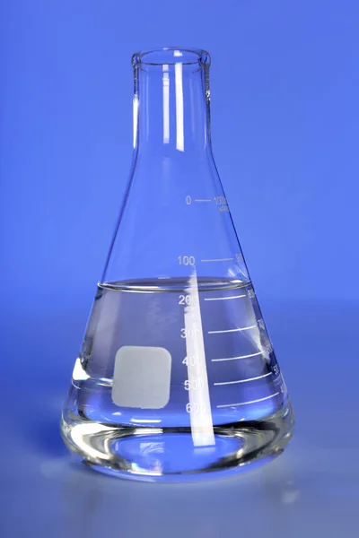 Laboratory Flask on Blue Background — Stock Photo, Image