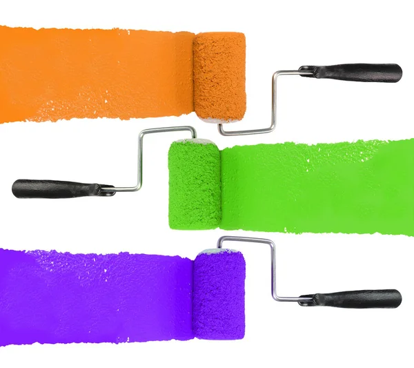 油漆滚筒与橙绿色和紫色 免版税图库图片