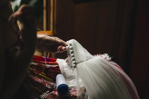 Donna cucitrice patching un abito da sposa con filo e ago — Foto Stock
