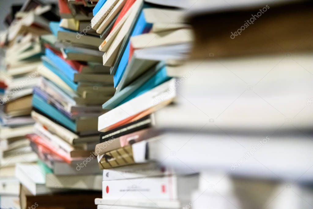 Many used stacked books ready to take to recycle.