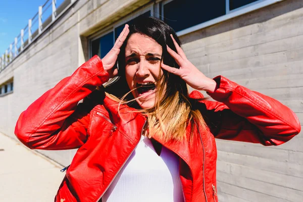 Scared woman is scared and makes a panic face while screaming fo