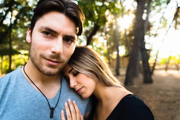 Woman leaning on her boyfriend's shoulder, while he looks at the — Stok fotoğraf