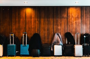 Travel suitcases lined up in a spacious hotel room of Asian tour