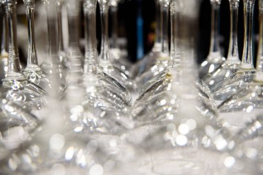 Detail of many clear and clean glass glasses arranged on the tab