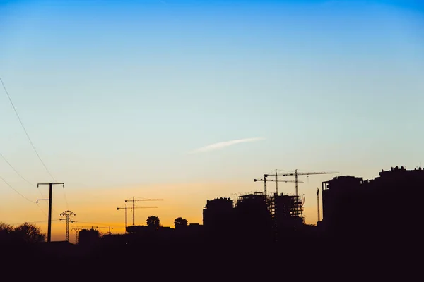 Silueta Atardecer Edificios Construcción Con Grúas Albañiles —  Fotos de Stock