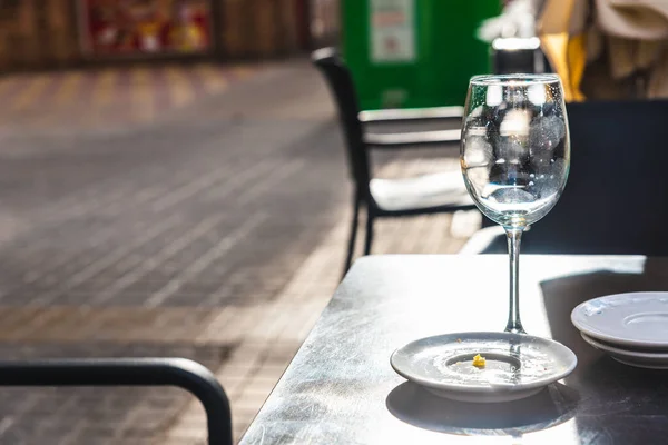Empty glass of beer that a bar customer leaves abandoned on the terrace of a street without paying.
