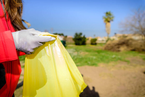 Garbage bags full of plastic bottles abandoned in nature recycled by volunteers.