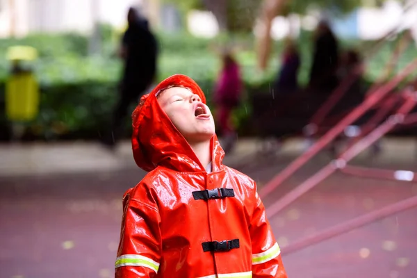 Funny Child Dressed Red Raincoat Firefighter Play Park Rainy Day — 图库照片