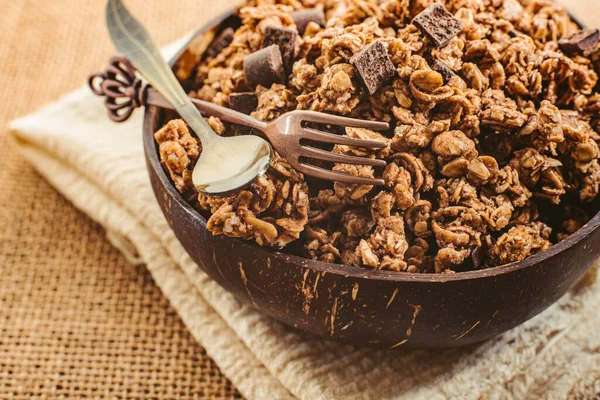 A wooden bowl full of muesli for the snack of athletes who want to keep fit.