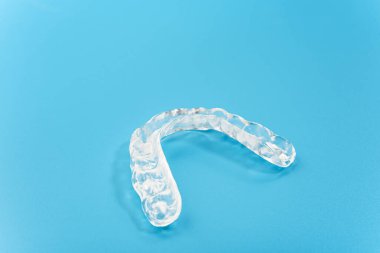 Mavi arka planda izole edilmiş diş doktorları tarafından kullanılan diş hizalayıcısı.