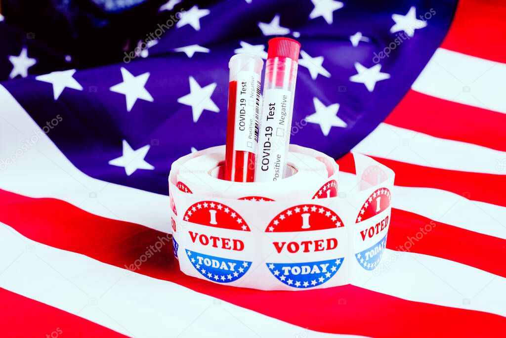 I voted sticker on the American flag and some test tubes of covid19 during the election time in the United States.