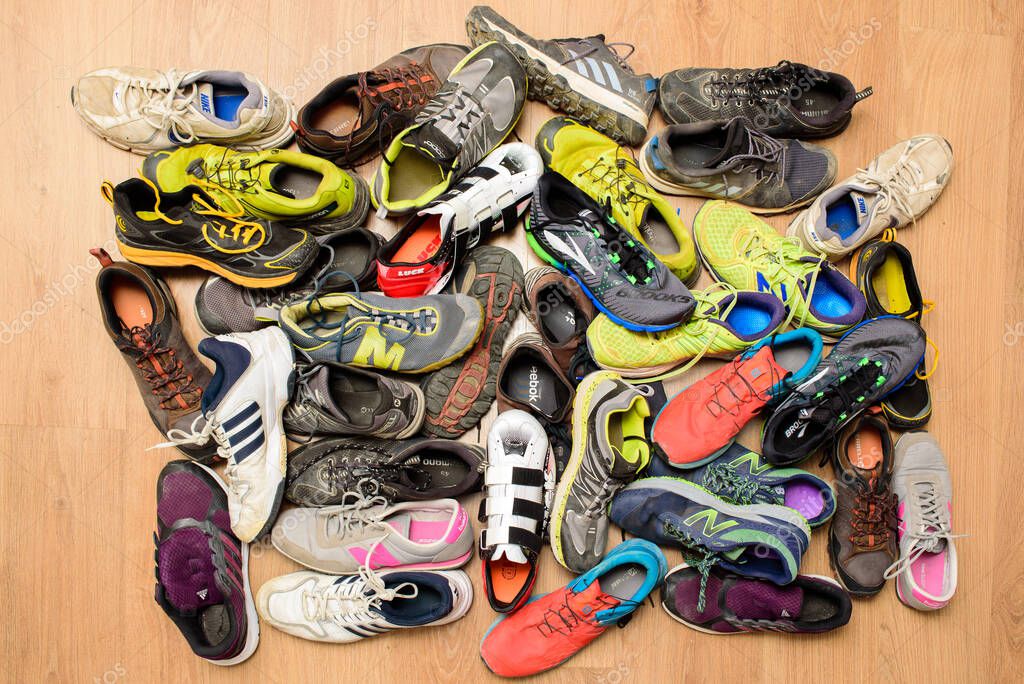 Valencia, Spain - April 7, 2020: Pile of used running sports shoes from various brands.