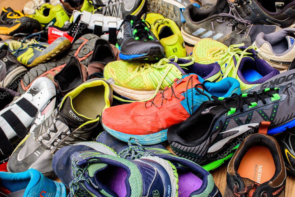 Valencia, Spain - April 7, 2020: Pile of used running sports shoes from various brands.