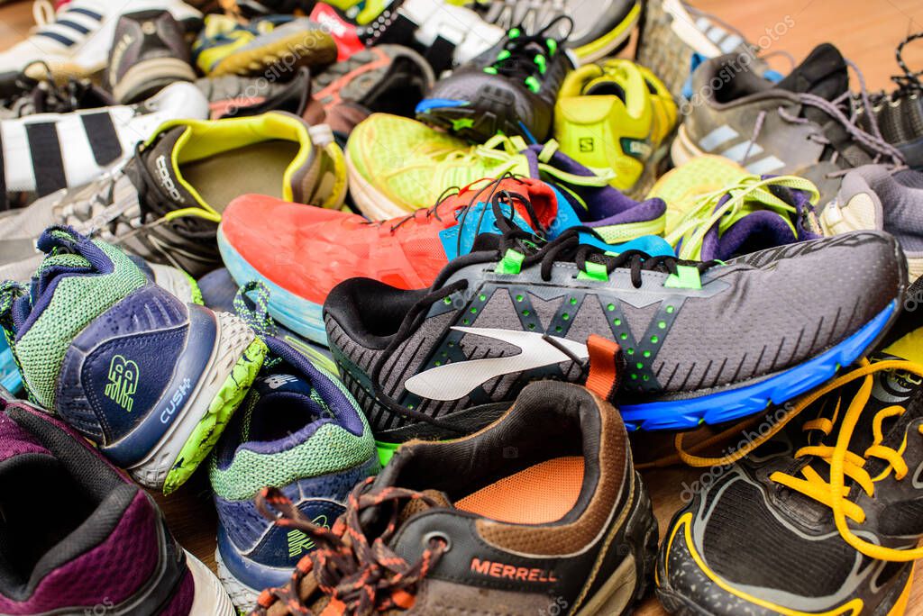 Valencia, Spain - April 7, 2020: Pile of used running sports shoes from various brands.
