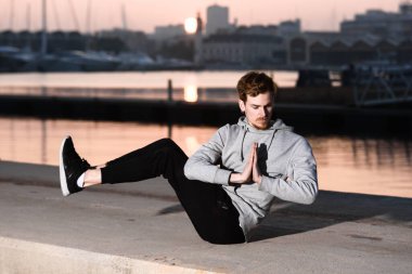 Genç Yogi ellerini Namaste 'nin selamlama pozisyonunda tutarak zihnini endişelerden arındırıyor..