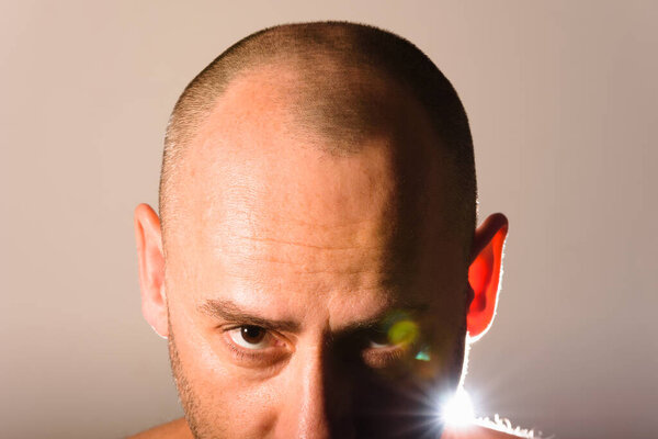 Bald man face portrait with freshly cut hair, isolated on background.