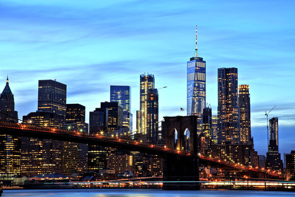 New York City Manhattan Downtown with Brooklyn Bridge at dusk