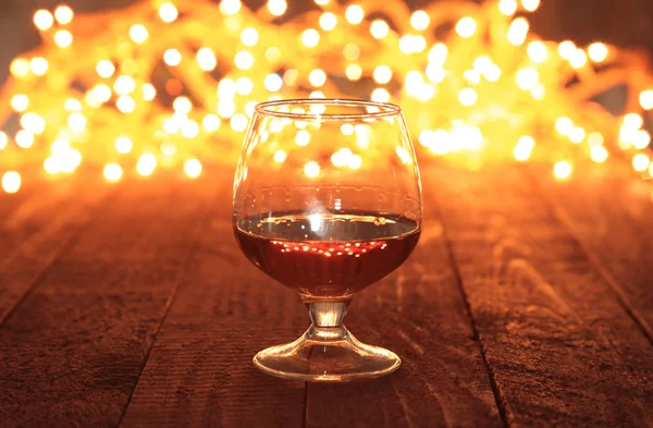 Photo cognac glass in front of bokeh background — Stock Photo, Image