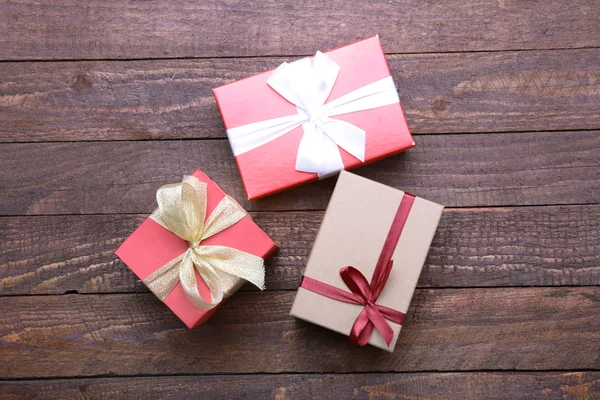 Christmas Composition with Gift box and light, red balls on wooden table — Stockfoto