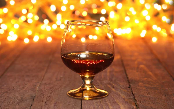 Photo cognac glass in front of bokeh background — Stock Photo, Image