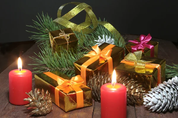 Christmas Composition with glass cognac, Gift box and candle on wooden table — Stock Photo, Image