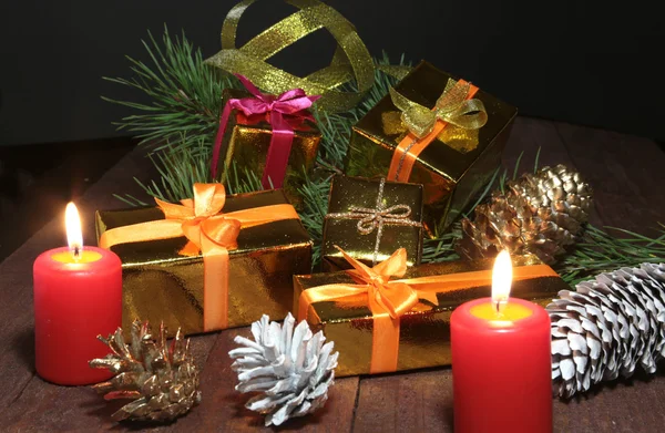 Christmas Composition with glass cognac, Gift box and candle on wooden table — Stock Photo, Image