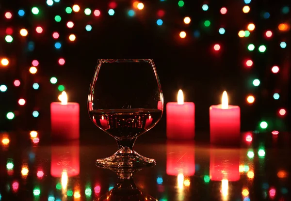 Christmas composition photo cognac glass and candle on black background — Stock Photo, Image