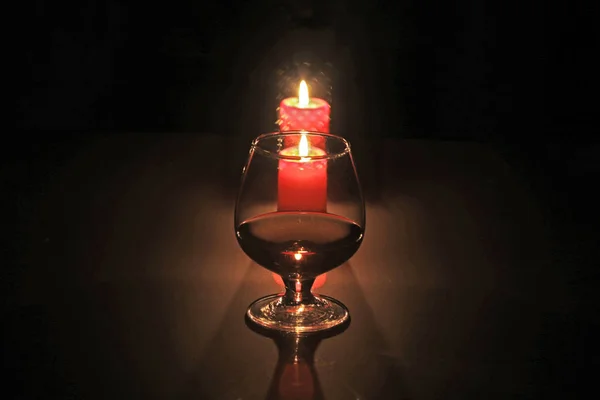 Christmas composition photo cognac glass and candle on black background — Stock Photo, Image