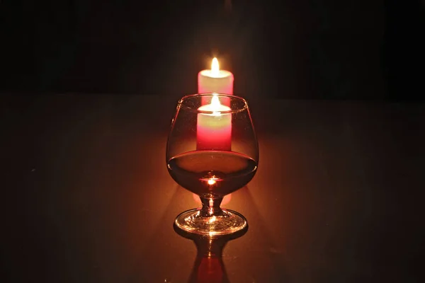 Christmas composition photo cognac glass and candle on black background — Stock Photo, Image