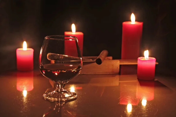 Christmas composition photo cognac glass and candle on black background — Stock Photo, Image