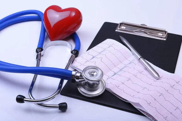 Cardiogram with stethoscope and red heart on table, closeup — Stock Photo, Image