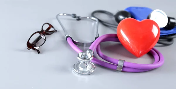 Red heart and a stethoscope on white background — Stock Photo, Image