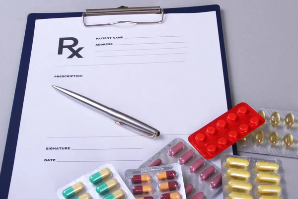 Closeup of a pils, stethoscope, pen on an rx prescription. — Stock Photo, Image