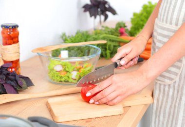 Kesme tahtası üzerinde taze sebze tencerede pişirme kavramı düşüyor