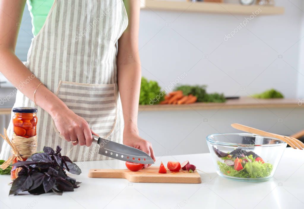 Fresh vegetables on the cutting board are falling in the pot, concept of cooking