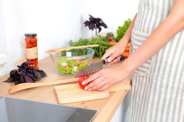 Kesme tahtası üzerinde taze sebze tencerede pişirme kavramı düşüyor