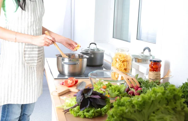 stock image Fresh vegetables on the cutting board are falling in the pot, concept of cooking